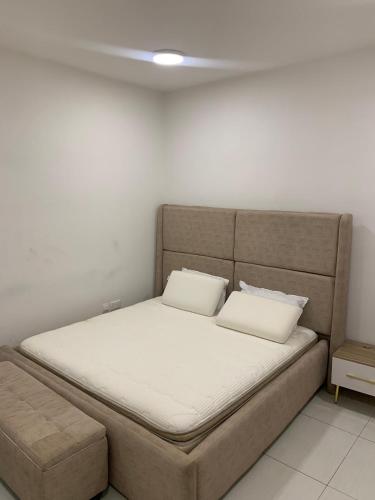 a bed with two pillows on it in a room at Golf news inspire living in Benin City