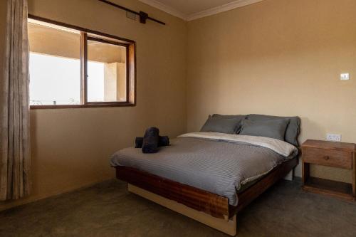 a bedroom with a bed and a window in it at Rain Tree Camp in Chunga