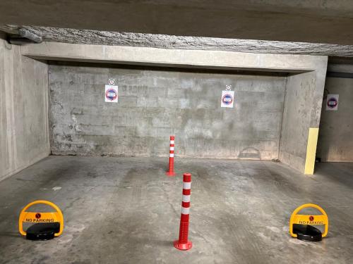 a parking garage with two orange cones in it at Le Yéti T4 air-conditioned Lyon Eurexpo stadium LDLC arena in Chassieu