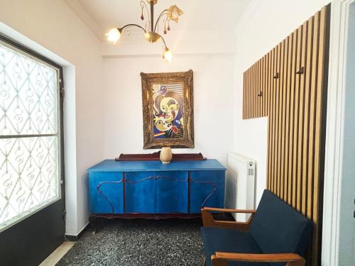 a blue table in a room with a blue chair at The Local Pin House - Ευρύχωρη μονοκατοικία, Λαμία in Lamía