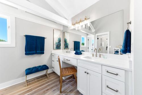 a white bathroom with a sink and a mirror at On the Canal at Perdido Key - Private Outdoor Pool, Luxury Accommodations + Beautiful Views of the Canal in Perdido Key