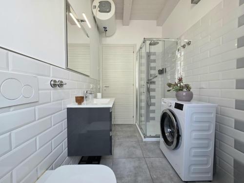 a bathroom with a washing machine and a sink at Palazzo Galileo in San Benedetto del Tronto