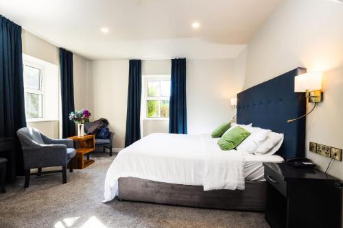 a bedroom with a large bed with a blue headboard at Casey's Of Baltimore Collection in Baltimore