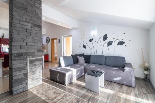 a living room with a couch and a fireplace at Seabreeze Apartments with Shared Jacuzzi in Senj