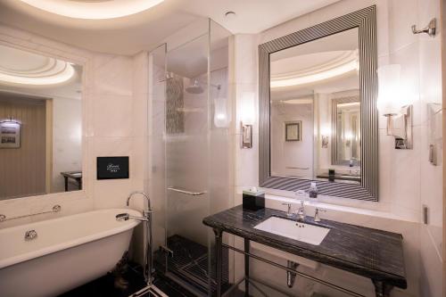 a bathroom with a sink and a mirror at Fairmont Peace Hotel on the Bund in Shanghai
