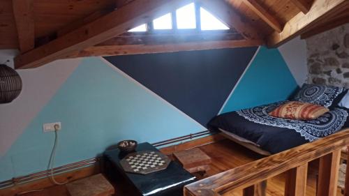 an attic room with a bed and a window at Casa Almenara in Almenara de Tormes