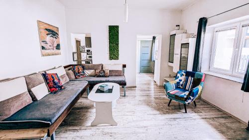 a living room with a couch and a table and chairs at LTE Apartments in Maribor