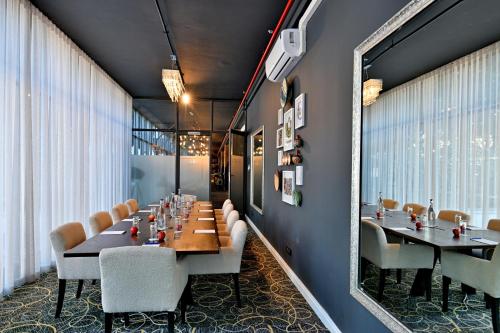 a dining room with tables and chairs and a mirror at Fountains Hotel in Cape Town