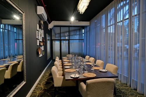 a long dining room with a long table and chairs at Fountains Hotel in Cape Town