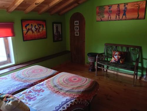 a bedroom with green walls and a bed and a window at Casa Almenara in Almenara de Tormes