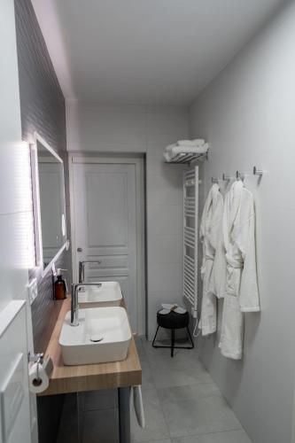 a white bathroom with a sink and a mirror at Villa Saint-Lager - Séjour de charme au cœur du Beaujolais in Saint-Lager