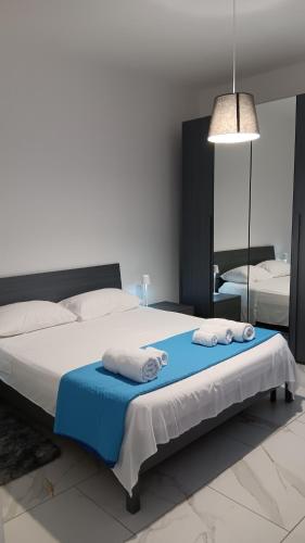 a bedroom with a bed with two towels on it at La Casa di Betta in Sant’Agata Li Battiati 