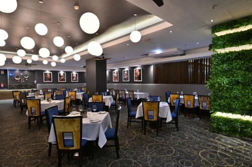 a dining room with tables and chairs and lights at Fountains Hotel in Cape Town