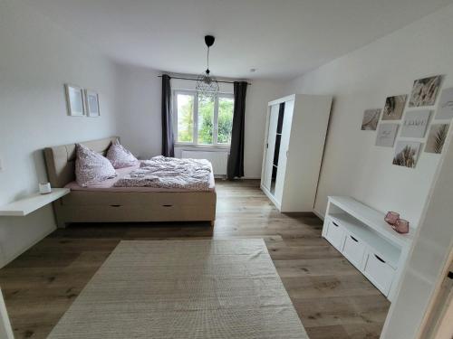 a bedroom with a bed and a window at Ferienwohnung WineTime in Saarburg