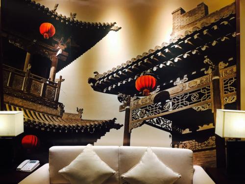 a living room with a couch and some lanterns at Water Hotel, Pingyao in Pingyao