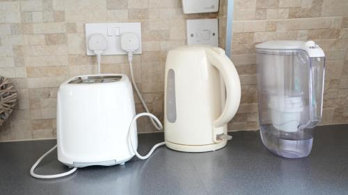 two appliances sitting on a counter in a kitchen at Lux Apartment in Gatwick in Crawley