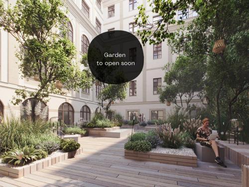 a person sitting on a bench in front of a building at The Botanist by Adrez in Prague