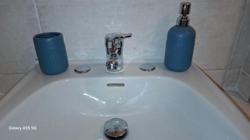 a white sink with two blue bottles on top of it at Bed and Breakfast La Reale in Stintino