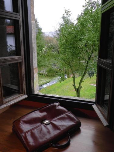 a brown purse sitting in front of a window at Casona de San Pantaleón de Aras in San Pantaleón de Aras