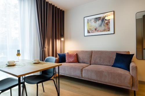 a living room with a couch and a table at Hessnery Hotel in Tallinn
