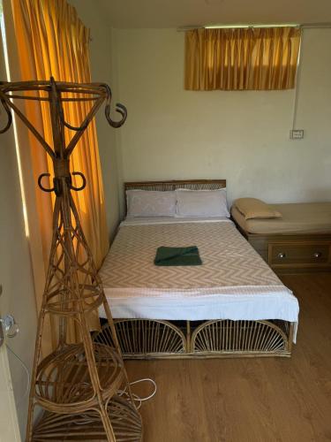 a small bed in a room with a bed frame at Peaceful lakeview in Rānīpauwa