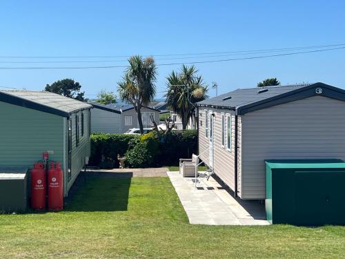 a couple of small buildings in a yard at Sher, My Happy super static in Llanddwywe