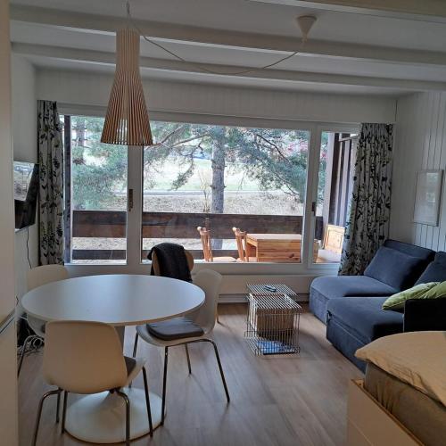 a living room with a table and a couch at Le Flocon Studio in Ovronnaz close to the baths in Ovronnaz