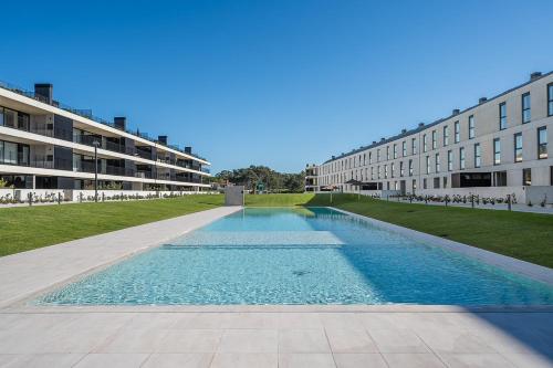 an empty swimming pool in front of a building at GuestReady - A charming place in a private condo in Apúlia