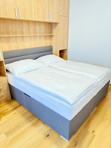 a bed in a small room with a mattressvisorvisor at Riverside Apartment Praha in Prague