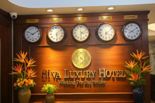 a group of clocks on a wall in a store at Hanoi Siva Luxury Hotel & Travel in Hanoi
