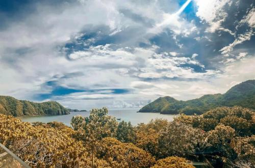 a view of a lake with mountains in the background at 1BR at Jacana B Pico de Loro in Nasugbu
