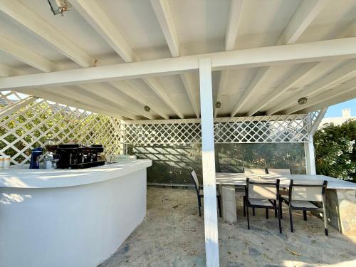 a patio with a table and chairs under awning at Yaleena Residences in Drios