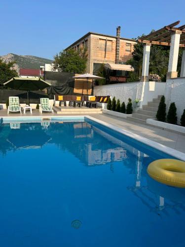 a swimming pool with a yellow frisbee in the water at Riviera Blagaj in Blagaj