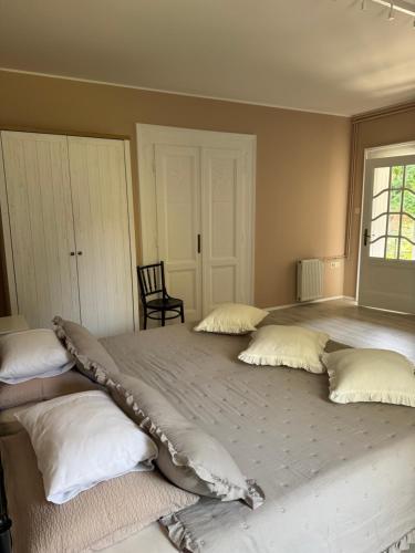 a bedroom with a large bed with four pillows at Bed and Breakfast "Caffe-caffe" in Kikinda
