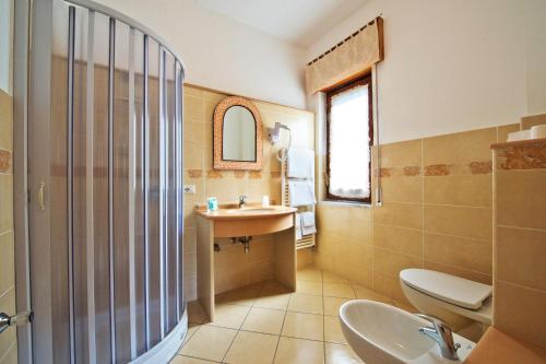 a bathroom with a sink and a toilet and a mirror at Haidi House in Agerola