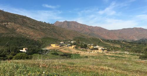 a village on a hill with mountains in the background at La Careza De Mijas - Adults Only in Mijas