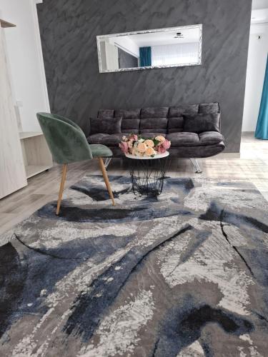 a living room with a couch and a table at RUXO Hotel in Mamaia Nord