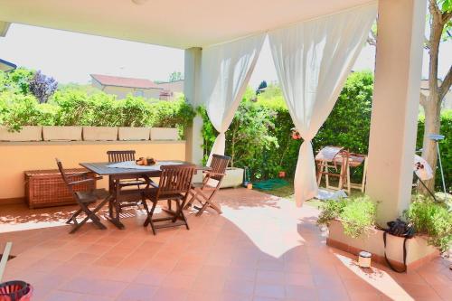a patio with a table and chairs on a patio at Bilocali Perseo in Marina di Bibbona