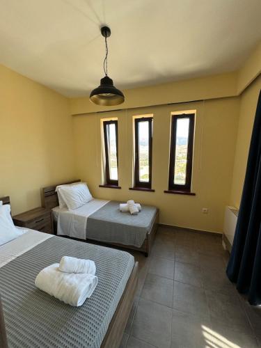 two beds in a room with windows at Endless View in Mythimna