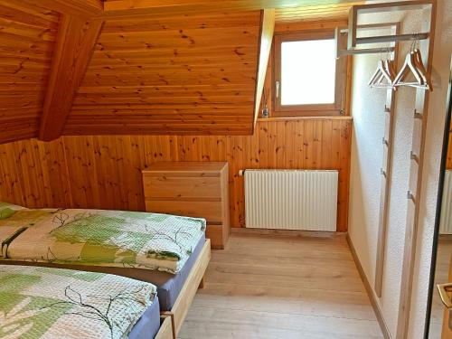 a bedroom with two beds and a window at Hotel Bellevue in Sierre