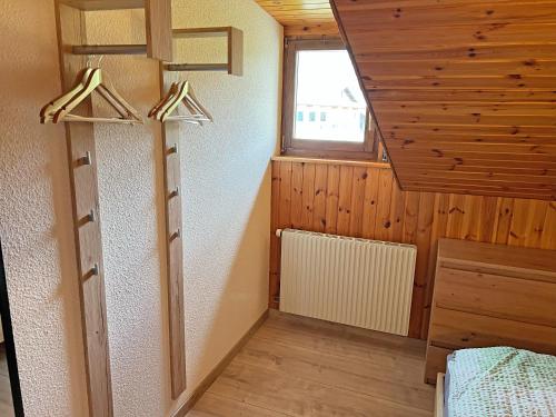 a room with wooden walls and a ceiling with a window at Hotel Bellevue in Sierre