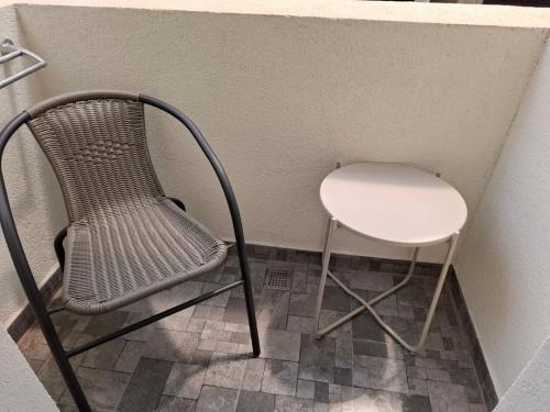 a chair and a stool in a corner at RUXO Hotel in Mamaia Nord