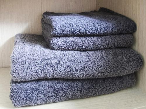 a pile of towels sitting on a wall at Calm house Beppukitahama in Beppu