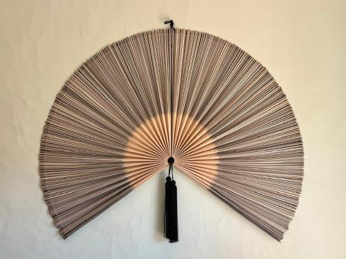 a large brown fan hanging on a wall at New Flat with View over the River Zezere in Casalinho de Santana