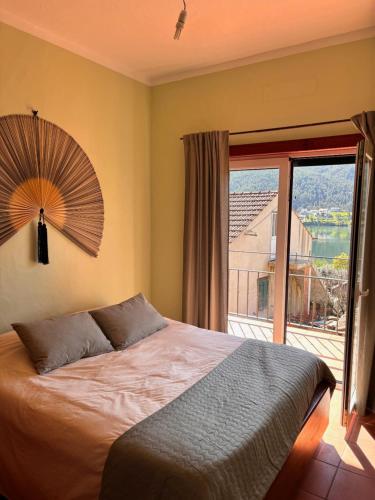 a bedroom with a large bed and a large window at New Flat with View over the River Zezere in Casalinho de Santana