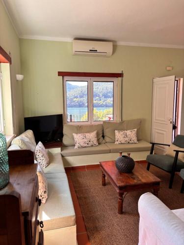 a living room with a couch and a table at New Flat with View over the River Zezere in Casalinho de Santana