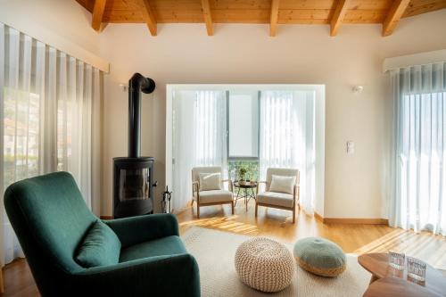 a living room with a green couch and a fireplace at Esatia Villa in Exanthia