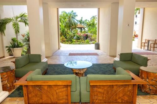 a living room with couches and a table at Napili Point by KBM Resorts in Kaanapali