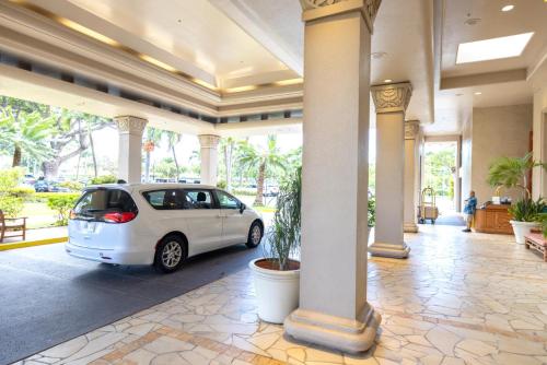 a white car parked inside of a building with columns at Napili Point by KBM Resorts in Kaanapali