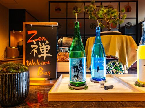 two bottles on a cutting board on a table at Super Hotel Kyoto Shijokawaramachi in Kyoto